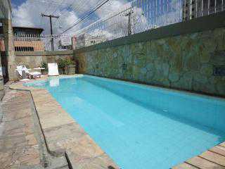 a swimming pool with blue walls and a blue fence 